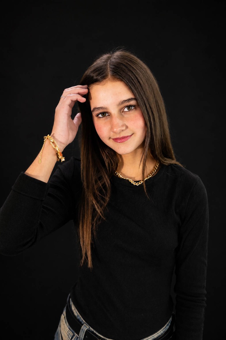 Young model posing for a portrait against a dark background