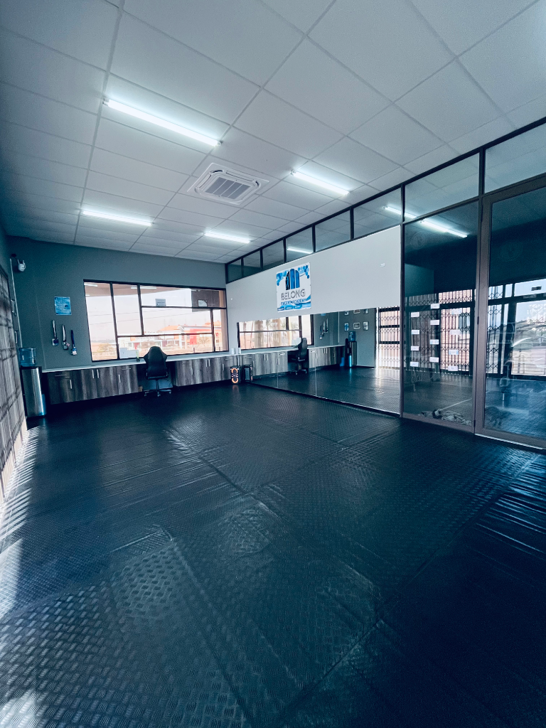 Wide view of the Belong dance studio with mirrored walls and open floor