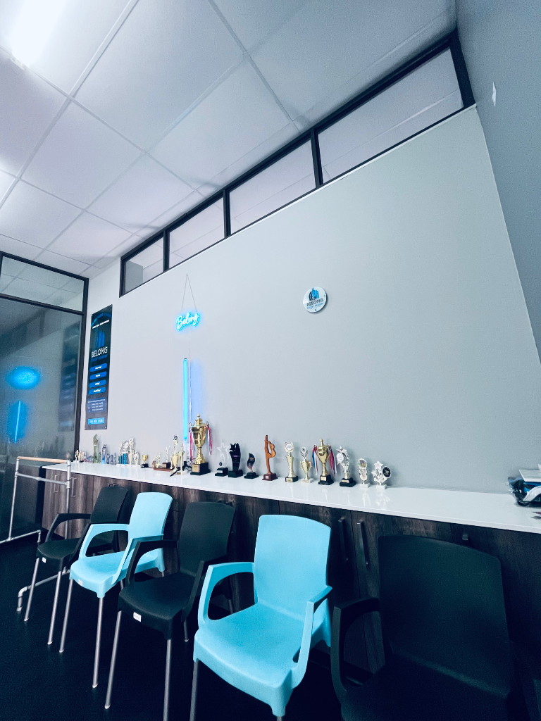 Studio reception area with chairs and student trophies